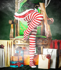 Obraz na płótnie Canvas Christmas time and slim young woman legs with smoke decoration 