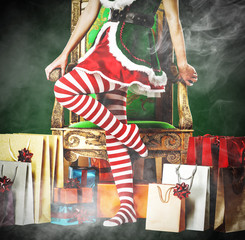 Christmas time and slim young woman legs with smoke decoration 