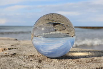 Fototapeta na wymiar The coast of sea in the glass ball