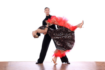 Latino dancers in ballroom against white background