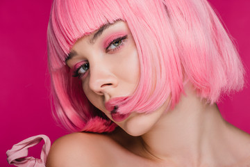 beautiful sensual girl posing in pink wig, isolated on pink