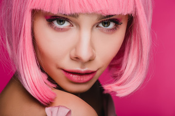beautiful girl posing in pink wig for fashion shoot, isolated on pink