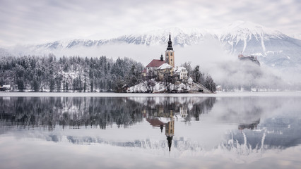 Landscape photo of island on the lake Bled with reflection on it