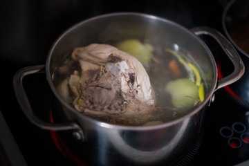 Boiled chicken with onion in stainless pot. Shallow depth of field.