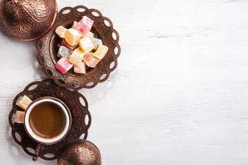 Traditional Turkish coffee and Turkish delight on white shabby wooden background. Top view. - 237696208