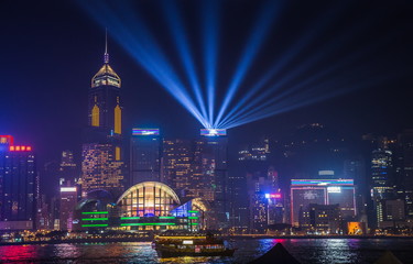 Fototapeta na wymiar View Night of Symphony of Lights and two boat of life at Victoria Harbor in Hong Kong.