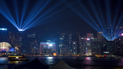 View Night of Symphony of Lights and two boat of life at Victoria Harbor in Hong Kong. © chayakorn