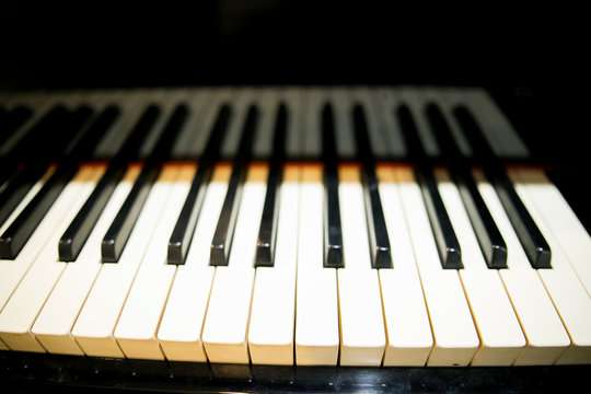 closeup musician hands playing piano on piano keyboard.low key tone image.concept for live music festival.Instrument on stage,classical music.abstract musical background.