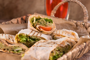 Pieces of vegetarian falafel roll on a wicker tray. Serving dishes.. Traditional Middle Eastern snack. Fastfood.
