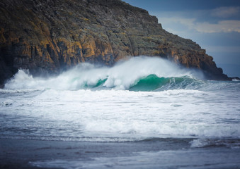 Huge crashing wave near the rocks in Porth Ceiriad near Abersoch, Wales, UK