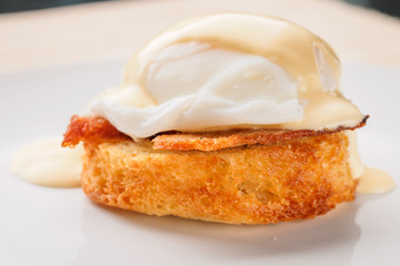 Breakfast is Eggs Benedict - toasted English muffins, bacon, ham, poached eggs, herbs and delicious buttery hollandaise sauce.