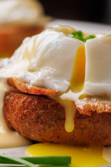 Breakfast is Eggs Benedict - toasted English muffins, bacon, ham, poached eggs, herbs and delicious buttery hollandaise sauce.