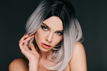 beautiful fashionable girl posing in grey wig, isolated on black