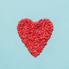 Valentine's card. Creative heart of red confetti. View from above. Flat lay.