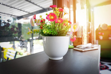 flower in cup / colorful of flower in white pot on wooden table