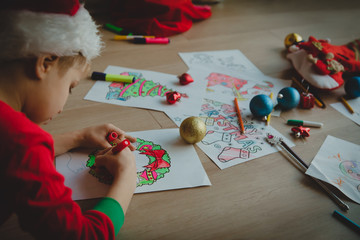 little boy prepare for Christmas, making crafts, draw and colour