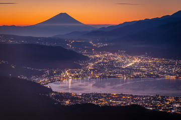 Mt. Fuji and Suwa lake at sunrise seen from Mt. Takabochi