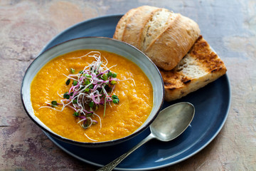 Carrot soup with the topping of green sprouts
