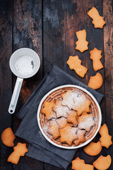 Homemade Christmas New year star shape gingerbread cookies in ceramic plate on old wooden vintage background. Top view with space.