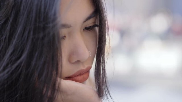 Sad thoughtful asian beautiful woman-macro-slow motion