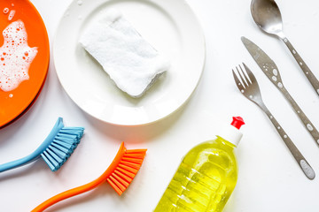 concept of washing dishes on white background top view