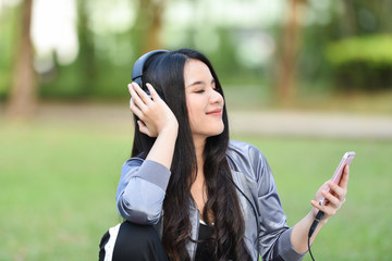 young woman listen to music with mobile phone outdoor happy smiling girl