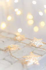 Fototapeta na wymiar festive garland with stars, glows. light background