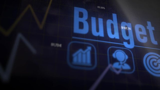Budget business concept on a flashing computer monitor with moving graphs and data.