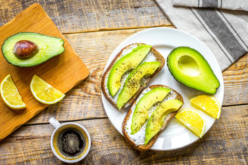 Fototapeta na wymiar making sandwiches with avocado healthy organic food top view