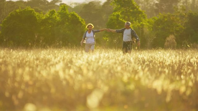 Happy senior Caucasian American couple on vacation enjoying their leisure walking together outdoors 