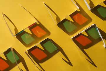 top view of 3d glasses with shadows on yellow background