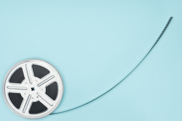 movie reel with cinema tape isolated on blue