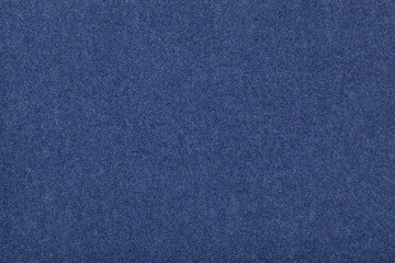 Navy blue matt suede fabric closeup. Velvet texture of felt.