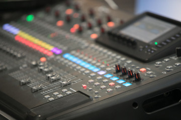 Fototapeta na wymiar The audio equipment, control panel of digital studio mixer, side view. Close-up, selected focus