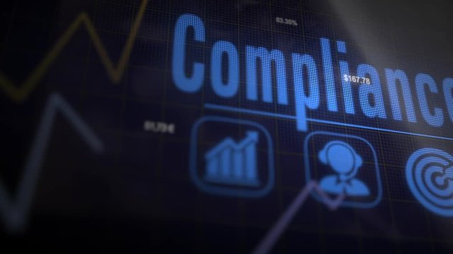 Compliance business concept on a flashing computer monitor with moving graphs and data.