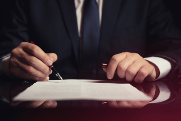 Lawyer, attorney signing a contract