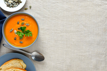Bowl of pumpkin soup served with seeds