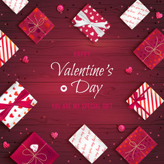 Happy Valentine's Day greeting background. Top view on gift boxes in different packaging, candy lollipops in the form of heart on a wooden table. Festive romantic love web banner. Vector illustration