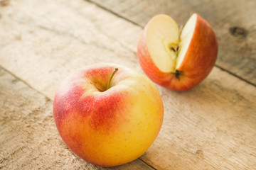 Tasty red apples on a wooden table