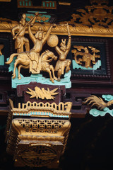Wooden relief showing an historic scene as entrance decoration of a Chinese temple in Suzhou, China, Asia
