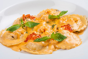 Ravioli with salmon on white background