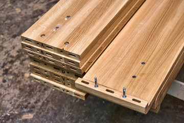 Wooden elements of a double bed. Furniture manufacture. Close-up