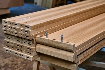 Wooden elements of a double bed. Furniture manufacture. Close-up
