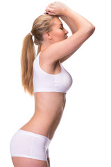 Fototapeta premium Young beautiful blonde woman in white fitness clothing
