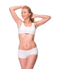 Naklejka na ściany i meble Young beautiful blonde woman in white fitness clothing