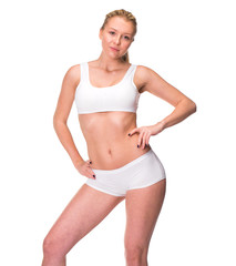 Young beautiful blonde woman in white fitness clothing