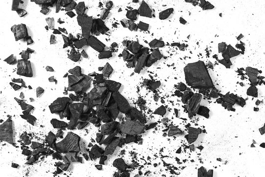 Black charcoal pile isolated on white background, top view