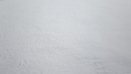 Low level flight over fresh white snow