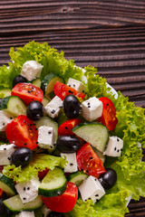 Greek salad on a wooden rustic background