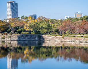 Grand and beautiful world famous Osaka castle in autumn with blue sky, Japan, close up
